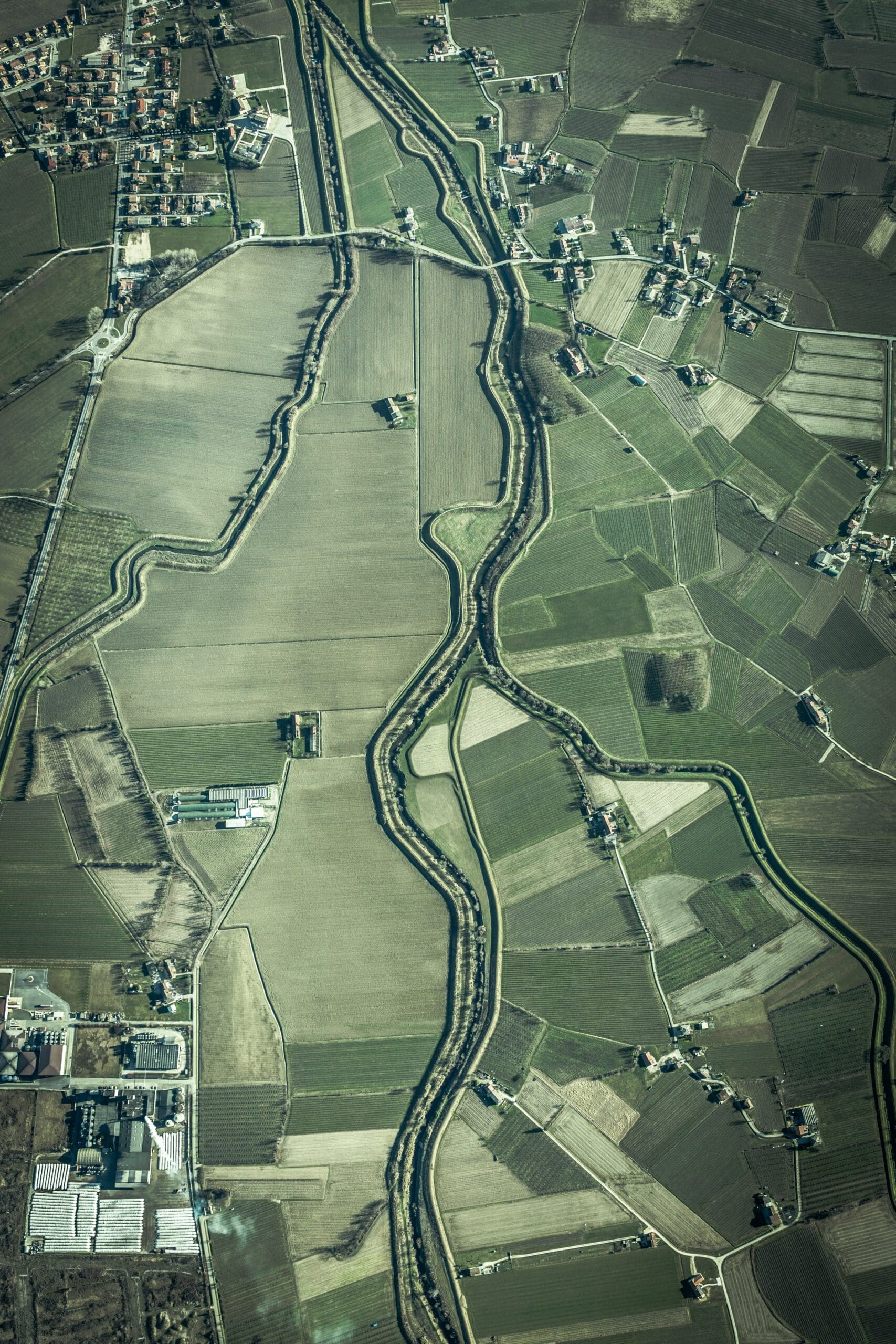 an aerial photo of tidy green agriculture fields